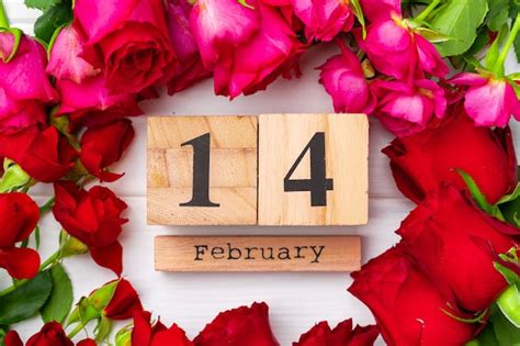 Premium Photo Wooden Calendar 14th February And Roses On Pink Flat Lay
