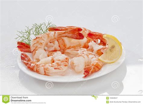 Steamed Jumbo Headless Shrimps With Deli Leaves And Lemon On White