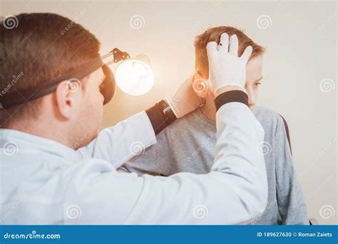 Doctor Examines Boy Ear With Otoscope Medical Equipment Stock Photo