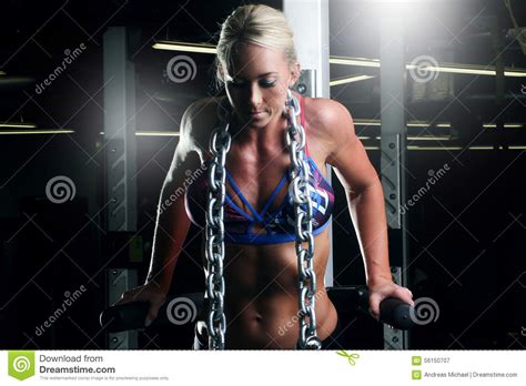 Fitness Woman Doing Triceps Exercises In The Gym With A Metal Chain