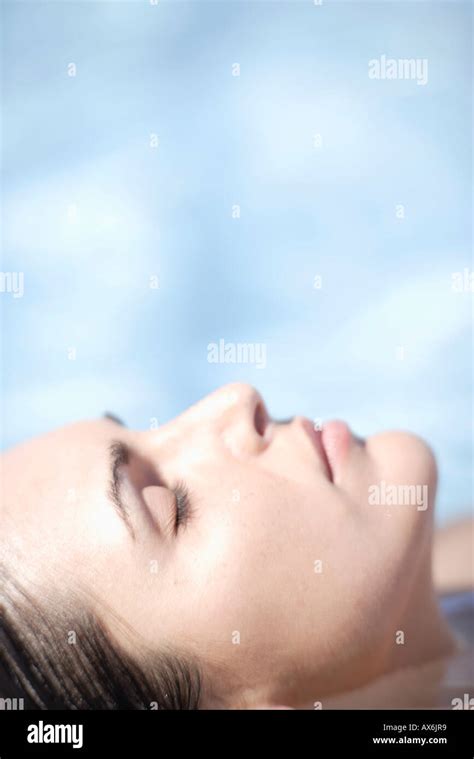Woman With Eyes Closed Relaxing In Pool Stock Photo Alamy