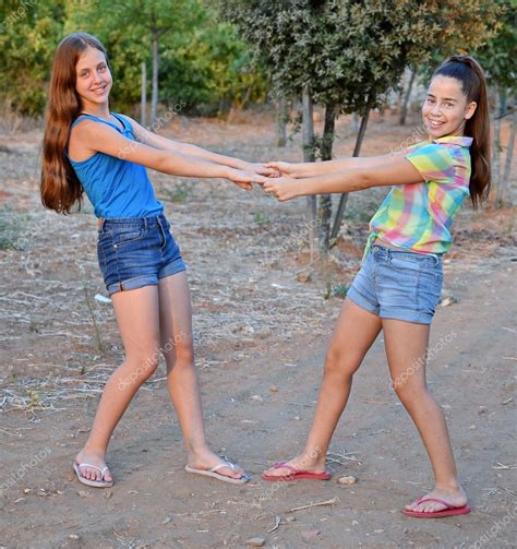 Two Best Friend Girls Holding Hands — Stock Photo © Dnaveh 51484781