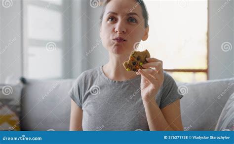 Hungry Woman Biting And Chewing Colourful Chip Cookie Close Up Stock