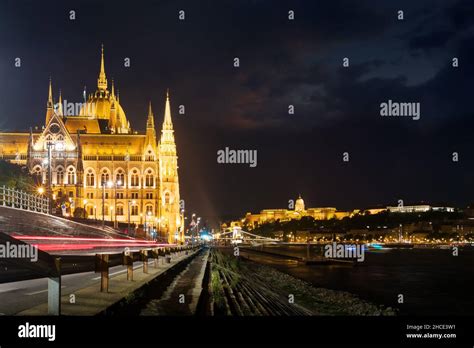 Hungarian Parliament Building By The River At Night Side View Stock