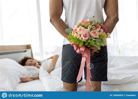 Young Man Hiding Bouquet Of Flower Behind His Back Before Surprise His