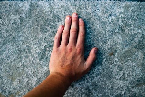 Left Human Hand On Grey Surface · Free Stock Photo