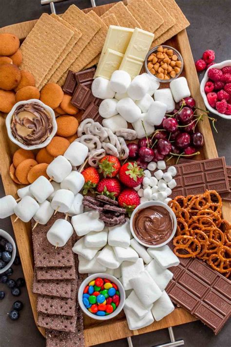 the ultimate smores dessert board loaded with all the toppings to make the perfect smore for