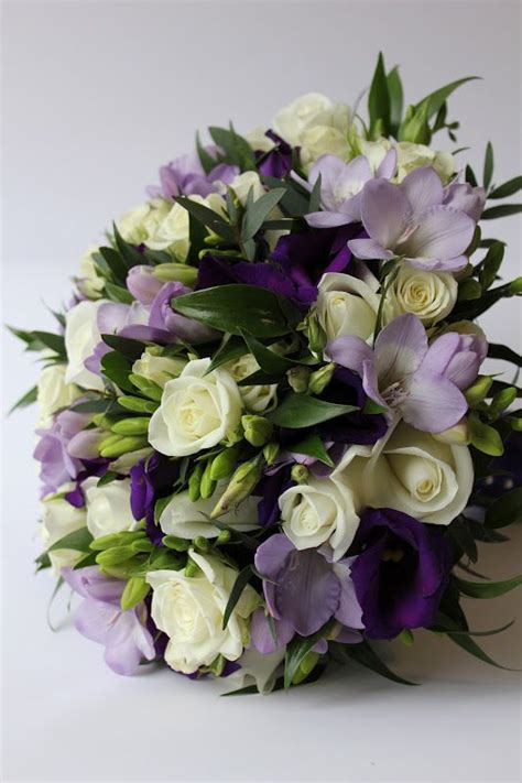 Purple and lilac wedding bouquets. Bridal Bouquet of dark purple Lisianthus, lilac Freesia ...