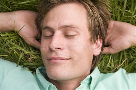 Man Lying On Grass Sleeping Stock Image Image Of Outdoors Head 5934669