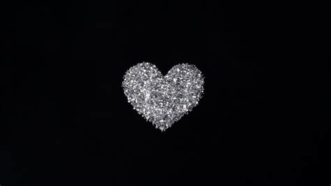 Silver Glitter Arrange To Heart Shape On Black Background