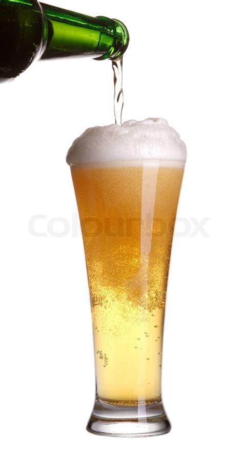Beer Pouring From Bottle Into Glass Isolated On White Stock Image