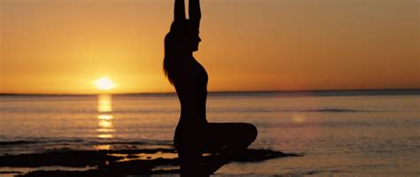 Woman Doing Yoga Near The Sea At Sunset Silhouette By Brad Day Royalty Free Stock Footage