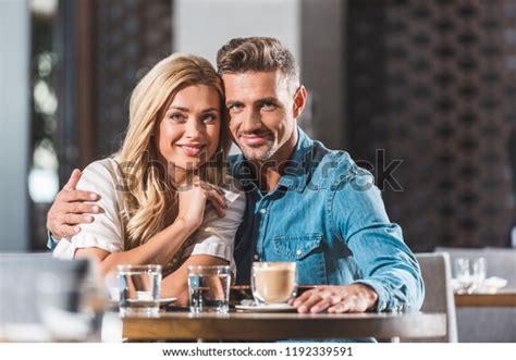 Happy Tender Heterosexual Couple Hugging Table Stock Photo 1192339591