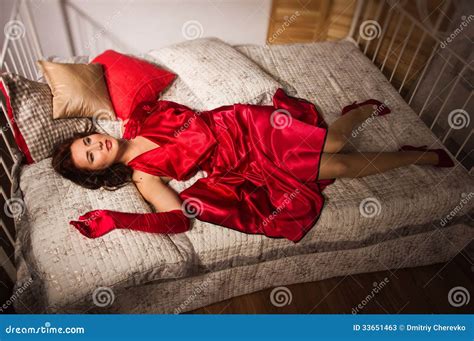 Sensual Brunette In A Red Dress Lying On The Bed Stock Image Image Of Adult Chamber 33651463
