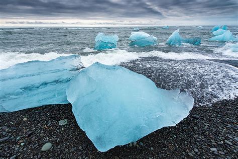 Cool Blue Glacier Ice On Black Beach In Iceland Photograph By Matthias