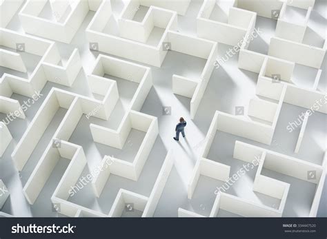 Business Challenge. A Businessman Navigating Through A Maze. Top View