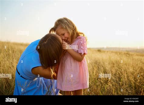 Mother And Daughter In Nature At Sunset Stock Photo Alamy