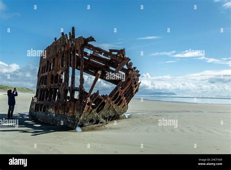 Tourist At Shipwreck Of The Peter Iredale Ship Fort Stevens State Park