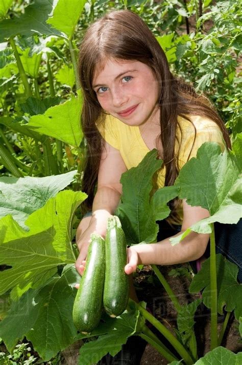 Girl Holding Cucumbers Stock Photo Dissolve