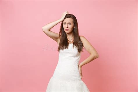 Portrait Of Concerned Puzzled Bride Woman In White Wedding Dress Stand