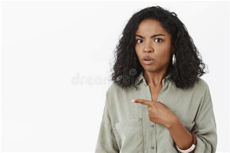 Confused African American Girl Posing And Looking At Camera Stock Photo