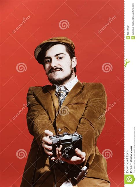 Very Positive Photographer Posing In Studio With Film Camera Stock