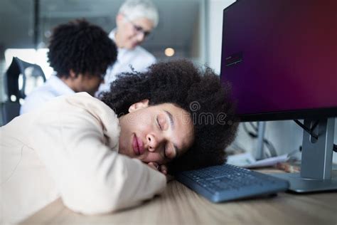 Portrait Of An Exhausted Business Woman Sleeping At Work Stock Image