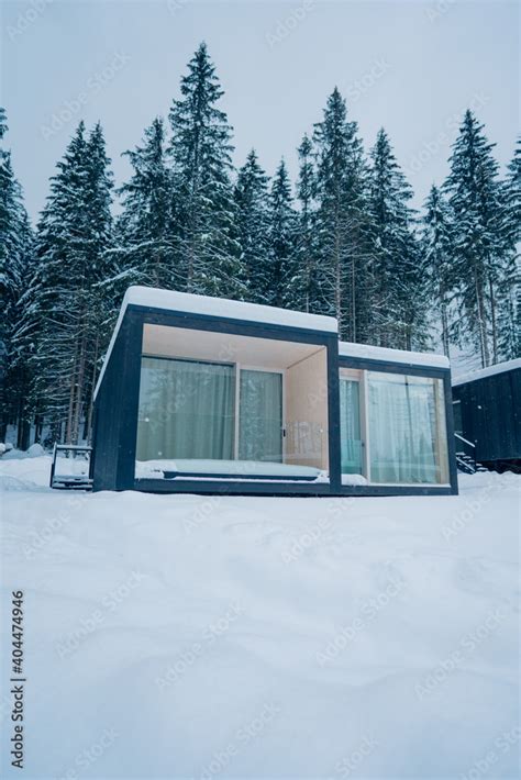 Modern Wooden Log Cabin And Snow Covered Trees In Winter Finland