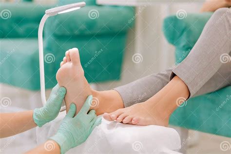 Experienced Chiropodist Making Feet Massage For Woman Stock Image