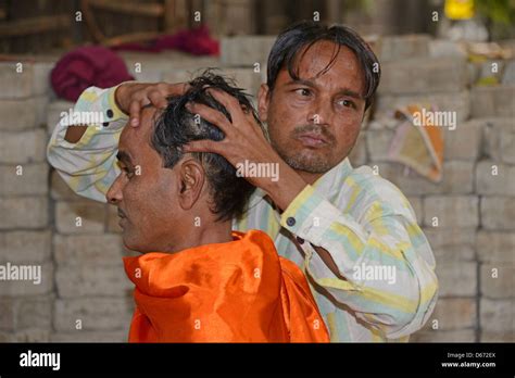 A Barber Giving His Client A Head Massage On A Street Pavement In Janpath Lane New Delhi India