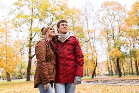 Happy Young Couple Walking In Autumn Park Stock Photo Image Of Fall