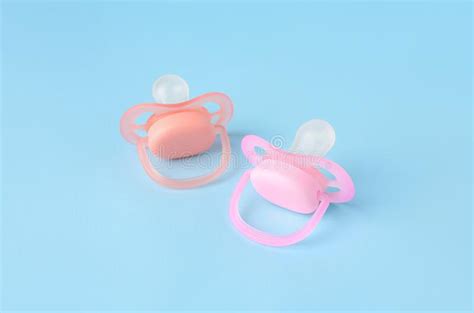Two New Baby Pacifiers On Light Blue Background Stock Image Image Of