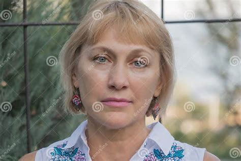 Portrait Of A Lovely Lovely Fifty Year Old Blonde Woman With A Sad Look