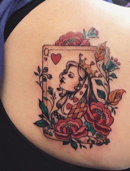 A Womans Lower Back Tattoo With Roses And Playing Card