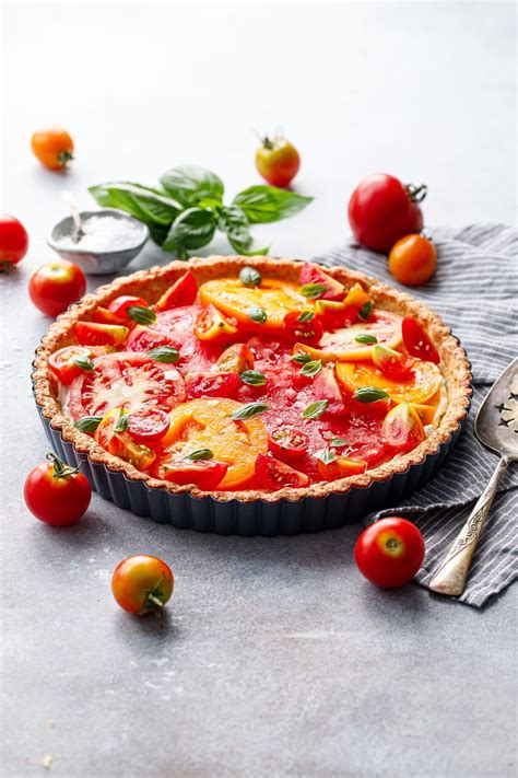 Heirloom Tomato And Goat Cheese Tart On A Gray Background Surrounded By