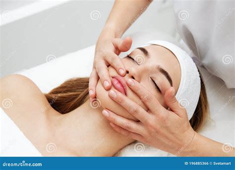 Beautician Massaging Woman`s Face Attractive Girl Having Facial Treatment And Massage Stock