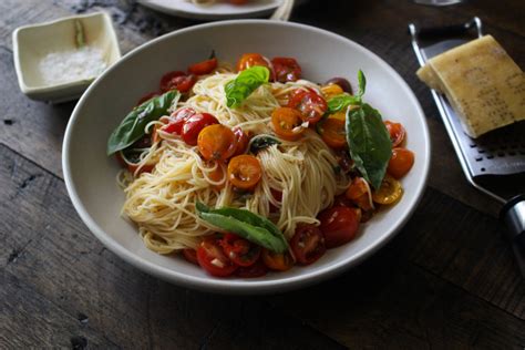 Angel hair pasta tossed in olive oil, fresh spices and tomatoes, topped with toasted pine nuts and sweet basil. Angel Hair Pasta with Summer Tomatoes - Dan330