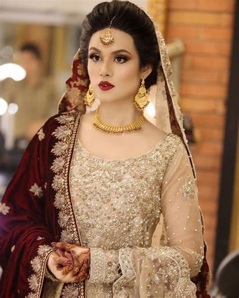 Intricate Gold Jewellery Pairing Up With A Deep Red Bridal Duppatta To Create A Traditional