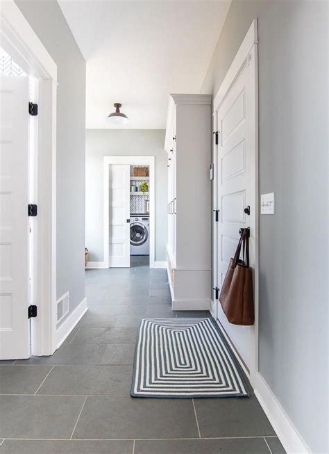 Blue And Gray Mudroom With Slate Tile For A Classic Feel In This Lake