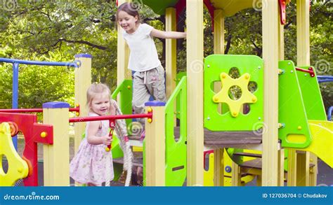 three girls on a play complex on the playground stock footage video of leisure smiling 127036704
