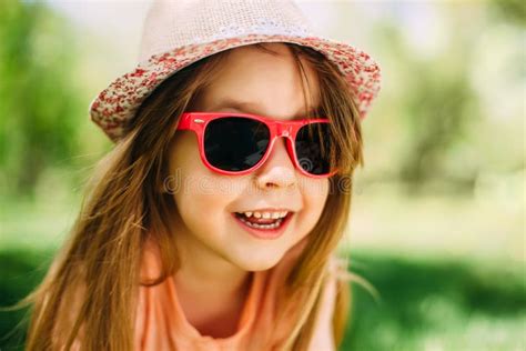 Little Cute Girl Wearing A Hat And Sunglasses Outdoors Stock Image Image Of Active Activity