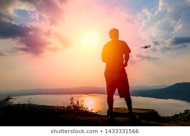 Man Operating Flying Drone Quadrocopter Sunset Stock Photo 1433331566