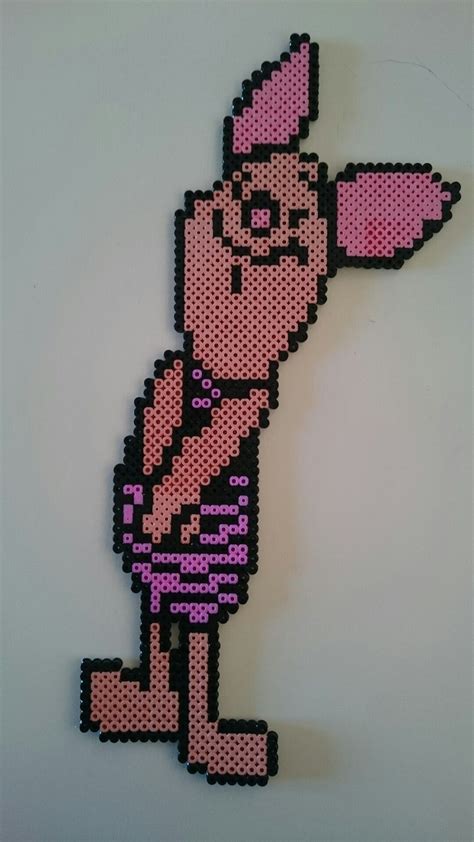 A Cartoon Character Made Out Of Perler Beads On A White Surface With