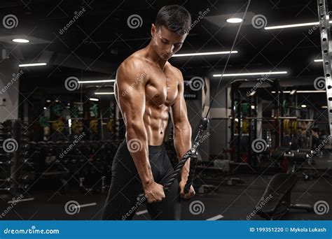 Muscular Man Working Out In Gym Doing Exercises For Triceps Strong
