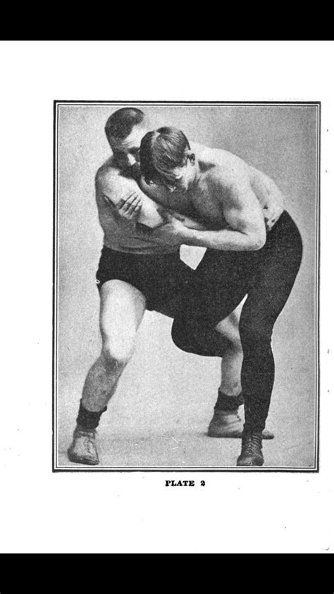 an old photo of two men wrestling in the middle of each other's body
