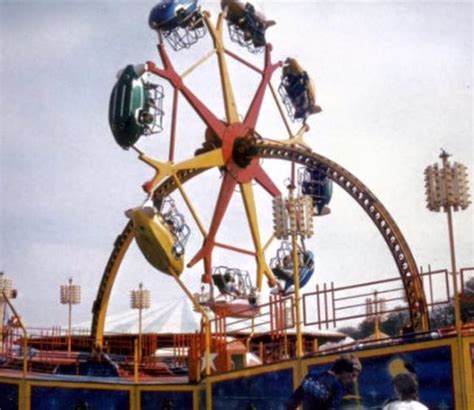 An Amusement Park Ride With People Riding It