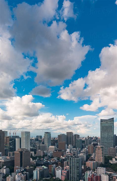 Clouds Over City Buildings By Stocksy Contributor Leslie Taylor