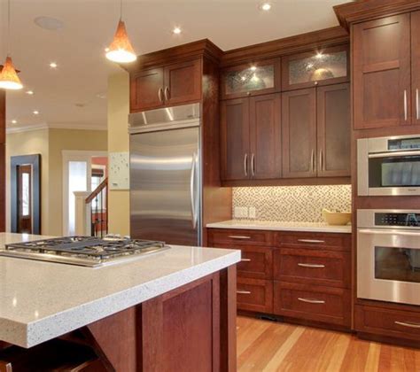 Cherry Wood Cabinets With Stainless And Light Countertop Kitchen