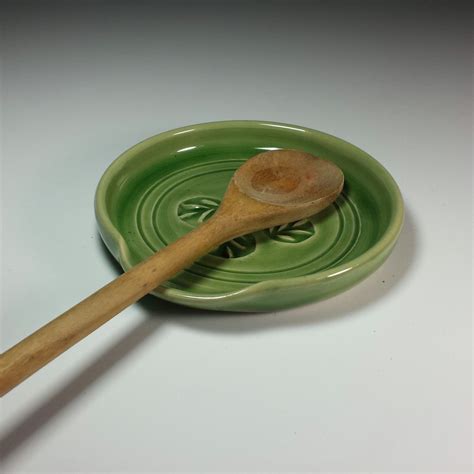 A Wooden Spoon Sitting On Top Of A Green Plate