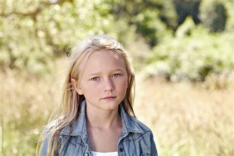 Portrait Of Little Girl With Blonde Hair Outdoors By Stocksy